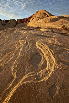 Erosion pattern in yellow sandstone under patterned clouds, Valley of Fire State Park, Nevada, United States of America Erosion pattern in yellow sandstone under patterned clouds, Valley of Fire State Park, Nevada, United States of America