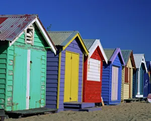 Exterior of a row of beach huts painted in bright primary colours, Brighton Beach Exterior of a row of beach huts painted in bright primary colours, Brighton Beach