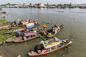 Families in their river boats at the local market in Chau Doc, Mekong River Delta Families in their river boats at the local market in Chau Doc, Mekong River Delta