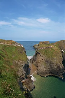 Figures crossing Carrick-A-Rede Bridge over cove Figures crossing Carrick-A-Rede Bridge over cove