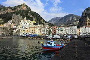 Fisherman in fishing boat and Amalfi town, Costiera Amalfitana (Amalfi Coast), UNESCO