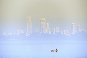A fisherman in front of the skyscrapers of the Malabar Hills in Mumbai (Bombay), Maharashtra A fisherman in front of the skyscrapers of the Malabar Hills in Mumbai (Bombay), Maharashtra