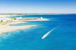 Fishing boat in the blue Ionian Sea, Torre Lapillo, Porto Cesareo, Lecce province Fishing boat in the blue Ionian Sea, Torre Lapillo, Porto Cesareo, Lecce province