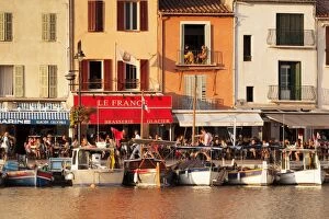 Stereotypically French Gallery: Fishing boats at the harbour, restaurants and street cafes on the promenade, Cassis