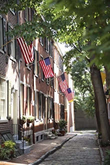 Flags displayed on homes on cobblestone American Street, in the Society Hill neighborhood of Philadelphia, Pennsylvania Flags displayed on homes on cobblestone American Street, in the Society Hill neighborhood of Philadelphia, Pennsylvania