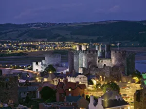 Floodlit Conwy Castle, UNESCO World Heritage Site, overlooking the town with the River Conwy estuary beyond at dusk, Gwynedd, North Wales, United Floodlit Conwy Castle, UNESCO World Heritage Site, overlooking the town with the River Conwy estuary beyond at dusk, Gwynedd, North Wales, United
