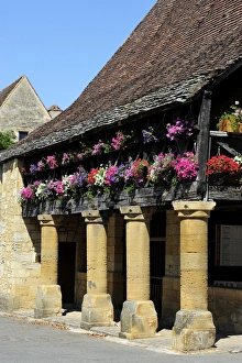 Flower bedecked medieval Les Halle, Bastide town of Domme, one of Les Plus Beaux Villages de France Flower bedecked medieval Les Halle, Bastide town of Domme, one of Les Plus Beaux Villages de France