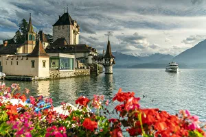 Flowers framing Oberhofen Castle and Lake Thun, Canton of Bern, Switzerland, Europe Flowers framing Oberhofen Castle and Lake Thun, Canton of Bern, Switzerland, Europe