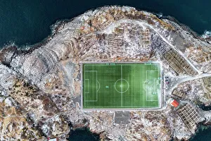 Football field on islet from above, aerial view, Henningsvaer, Nordland county, Lofoten Islands, Norway, Scandinavia Football field on islet from above, aerial view, Henningsvaer, Nordland county, Lofoten Islands, Norway, Scandinavia