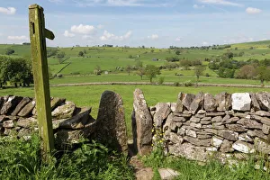 Footpath sign and stone stile with dry stone wall, near Alstonefield, Peak District National Park, Staffordshire Footpath sign and stone stile with dry stone wall, near Alstonefield, Peak District National Park, Staffordshire