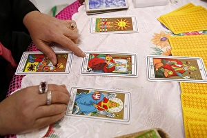 Fortuneteller laying cards on the table during a divination, Paris, France, Europe Fortuneteller laying cards on the table during a divination, Paris, France, Europe