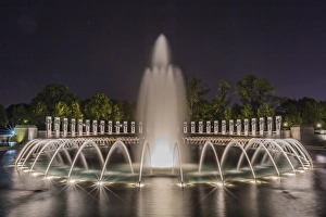 The fountains and sculpture of the World War II Memorial lit up at night, Washington D.C The fountains and sculpture of the World War II Memorial lit up at night, Washington D.C