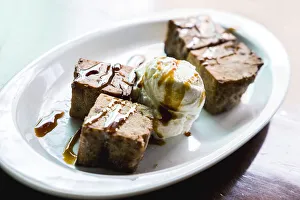 Fried Gofio, flour of roasted and ground cereal, in shape of brownies with ice cream Fried Gofio, flour of roasted and ground cereal, in shape of brownies with ice cream