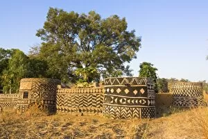 Geometric des igns painted on traditional hous es in s mall village in Tiebele area of Burkina Fas o