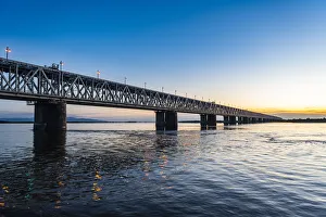 Giant bridge spanning over the Amur River at sunset, Khabarovsk, Khabarovsk Krai, Russia Giant bridge spanning over the Amur River at sunset, Khabarovsk, Khabarovsk Krai, Russia