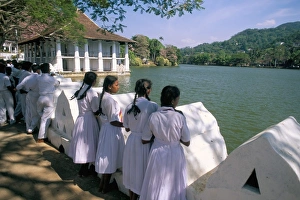 Girls standing on the edge of the artificial lake Girls standing on the edge of the artificial lake