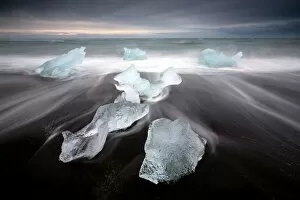 Images Dated 25th September 2014: Glassy pieces of ice on volcanic black sand beach with blurred waves, near Jokulsarlon Lagoon