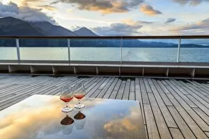 Glowing cognac (brandy) reflections, glass table at sunset, cruise ship stern, Resurrection Bay