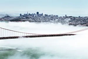Golden Gate Bridge and the San Francisco skyline floating above the fog on a foggy day in San Francisco, California Golden Gate Bridge and the San Francisco skyline floating above the fog on a foggy day in San Francisco, California
