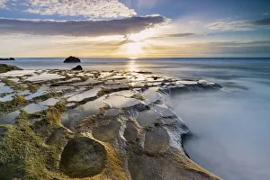 Golden hour over the ocean waves and rocks at El Cotillo beach, Fuerteventura Golden hour over the ocean waves and rocks at El Cotillo beach, Fuerteventura