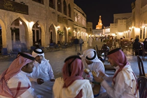 A group of men in Arabian dress in the restored Souq Waqif A group of men in Arabian dress in the restored Souq Waqif