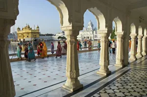 Group of Sikh women pilgrims walking around holy pool Group of Sikh women pilgrims walking around holy pool