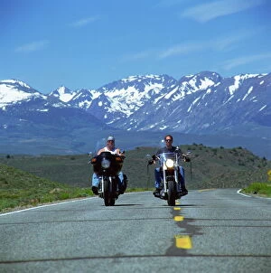 Images Dated 25th February 2008: Harley Davidson bikers with snow-capped mountains in background, United States of America
