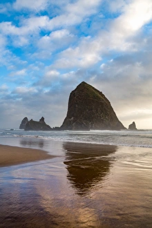 Haystack Rock reflected on the shoreline at Cannon Beach on the Pacific Northwest coast Haystack Rock reflected on the shoreline at Cannon Beach on the Pacific Northwest coast
