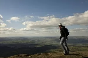 Hiker Gallery: A hiker walks north from Hay Bluff, above Hay-on-Wye, Brecon Beacons National Park