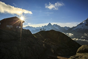 Hikers proceed towards Refuge of Lac de Cheserys with the sun just risen, Chamonix Hikers proceed towards Refuge of Lac de Cheserys with the sun just risen, Chamonix