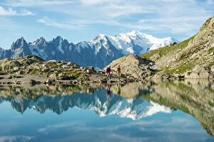 Hiker Gallery: Hikers and the summit of Mont Blanc reflected in Lac Blanc on the Tour du Mont Blanc