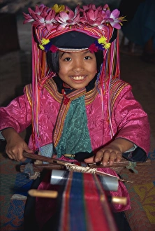 Hill tribe girl weaving on a narrow loom in Chiang Mai Hill tribe girl weaving on a narrow loom in Chiang Mai