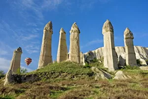 Hot Air Balloon Gallery: Hot air balloon over the phallic pillars known as fairy chimneys in the valley known as Love Valley near Goreme in Cappadocia
