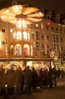 Hot wine (gluhwein) stall with Nativity Scene on roof at Christmas Market next to Frauen Church at night, Topfer Street