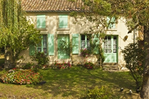 House with typical regional green shutters in the Marais Poitevin (Green Venice) wetlands House with typical regional green shutters in the Marais Poitevin (Green Venice) wetlands