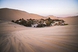 Huacachina and sand dunes at sunset in the desert in the Ica Region, Peru, South America Huacachina and sand dunes at sunset in the desert in the Ica Region, Peru, South America