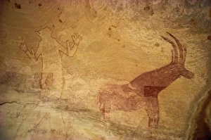 Rock Art Gallery: Huge painting of god figure and sable antelope on rock wall, Tassili Plateau