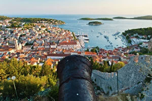 Croatia Gallery: Hvar Fortress cannon and Hvar Town at sunset taken from the Spanish Fort (Fortica), Hvar Island