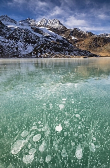 Ice bubbles in the turquoise water of the frozen White Lake (Lago Bianco), Bernina Pass Ice bubbles in the turquoise water of the frozen White Lake (Lago Bianco), Bernina Pass