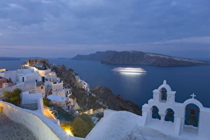 Illuminated cruise ship entering the caldera at dawn, Oia (Ia), Santorini (Thira) (Thera) Illuminated cruise ship entering the caldera at dawn, Oia (Ia), Santorini (Thira) (Thera)