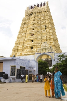An Indian family walks in front of the gopuram of the Ekambereshwara Temple in Kanchipuram An Indian family walks in front of the gopuram of the Ekambereshwara Temple in Kanchipuram