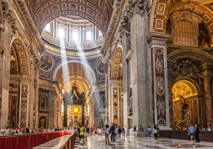Interior of St. Peters Basilica with light shafts coming through the dome roof Interior of St. Peters Basilica with light shafts coming through the dome roof