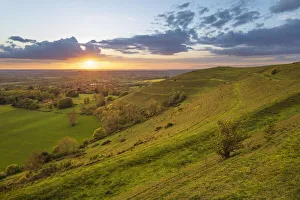 Iron-age hillfort of Hambledon Hill at sunset, Cranborne Chase AONB Iron-age hillfort of Hambledon Hill at sunset, Cranborne Chase AONB