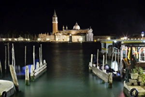 The island and church of San Georgio Maggiore at night with a boat dock in the foreground The island and church of San Georgio Maggiore at night with a boat dock in the foreground