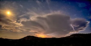 An isolated storm cell near Chino Valley being lit by the Moonlight during the summer An isolated storm cell near Chino Valley being lit by the Moonlight during the summer