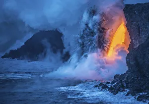 A Lava fall pours from a lava tube 60 feet high, the heat A Lava fall pours from a lava tube 60 feet high, the heat
