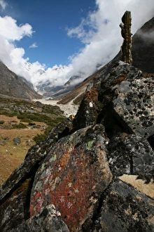 Lichen grows on an old Buddhist mani wall (prayer wall) constructed on the trail from Lukla to Tangnag, near Mera Peak, Khumbu region, Nepal Lichen grows on an old Buddhist mani wall (prayer wall) constructed on the trail from Lukla to Tangnag, near Mera Peak, Khumbu region, Nepal