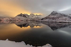 The light of the moon and snowy peaks reflected in the cold sea lit the night at Svolvaer The light of the moon and snowy peaks reflected in the cold sea lit the night at Svolvaer