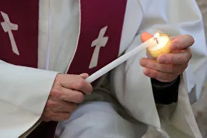 Lighting a candle on Day celebration of forgiveness, Amiens Cathedral, Picardy, France Lighting a candle on Day celebration of forgiveness, Amiens Cathedral, Picardy, France