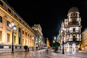 The lights of Sevilles buildings at night looking down the Avenida de la The lights of Sevilles buildings at night looking down the Avenida de la